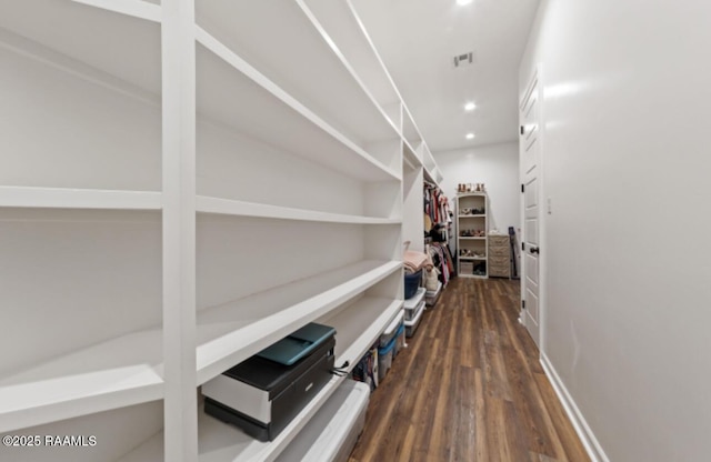 corridor with dark hardwood / wood-style flooring