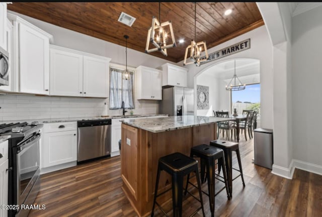 kitchen featuring appliances with stainless steel finishes, white cabinetry, and a kitchen island