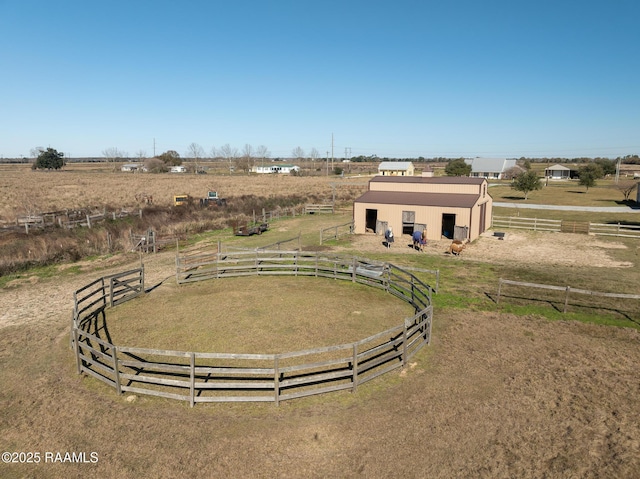 exterior space with an outdoor structure and a rural view