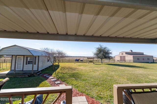 view of yard with a rural view and an outdoor structure