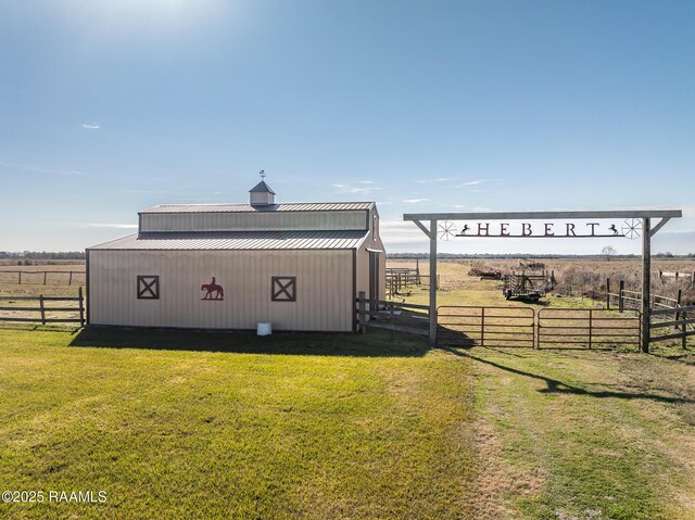 view of outbuilding featuring a yard and a rural view