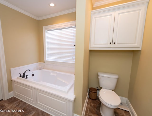 bathroom featuring ornamental molding, toilet, and a bathing tub