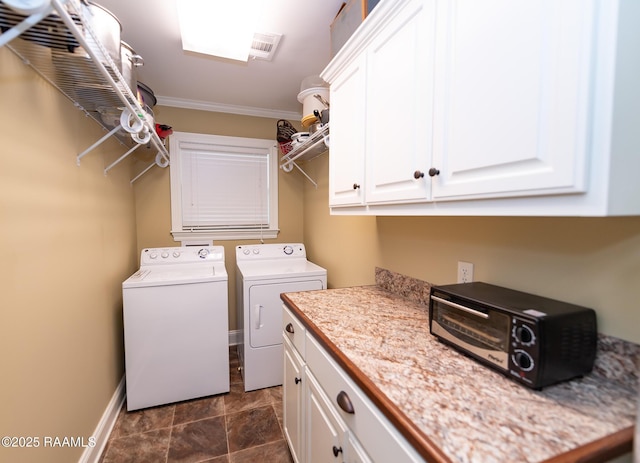 laundry room featuring cabinets, ornamental molding, and washer and dryer