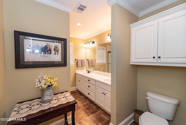 bathroom featuring vanity, ornamental molding, and toilet