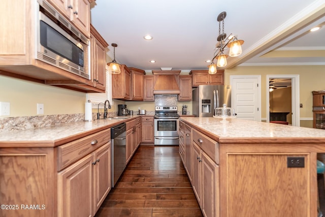 kitchen with sink, a center island, hanging light fixtures, custom range hood, and stainless steel appliances