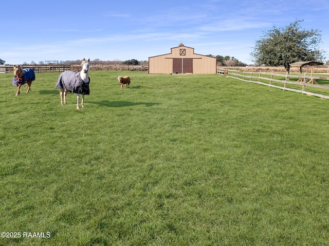 view of yard featuring an outbuilding and a rural view