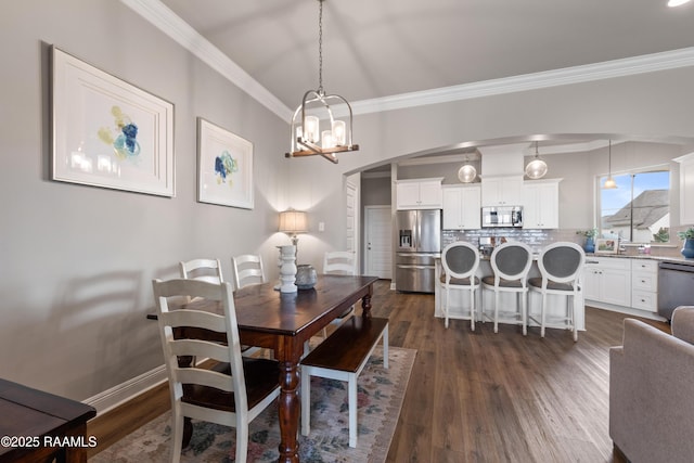 dining room featuring ornamental molding, a notable chandelier, and dark wood-type flooring