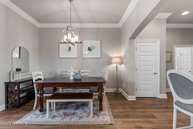 dining room featuring ornamental molding, a chandelier, and dark hardwood / wood-style flooring