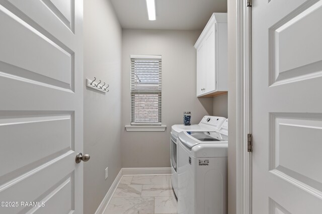 laundry room featuring cabinets and washer and clothes dryer