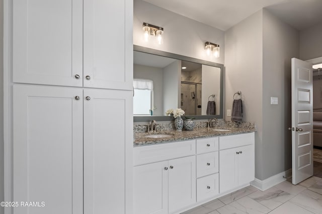 bathroom with vanity and a shower with shower door