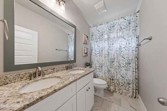 bathroom featuring toilet, curtained shower, vaulted ceiling, and vanity