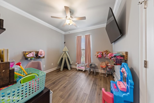 recreation room featuring ceiling fan, crown molding, and wood-type flooring