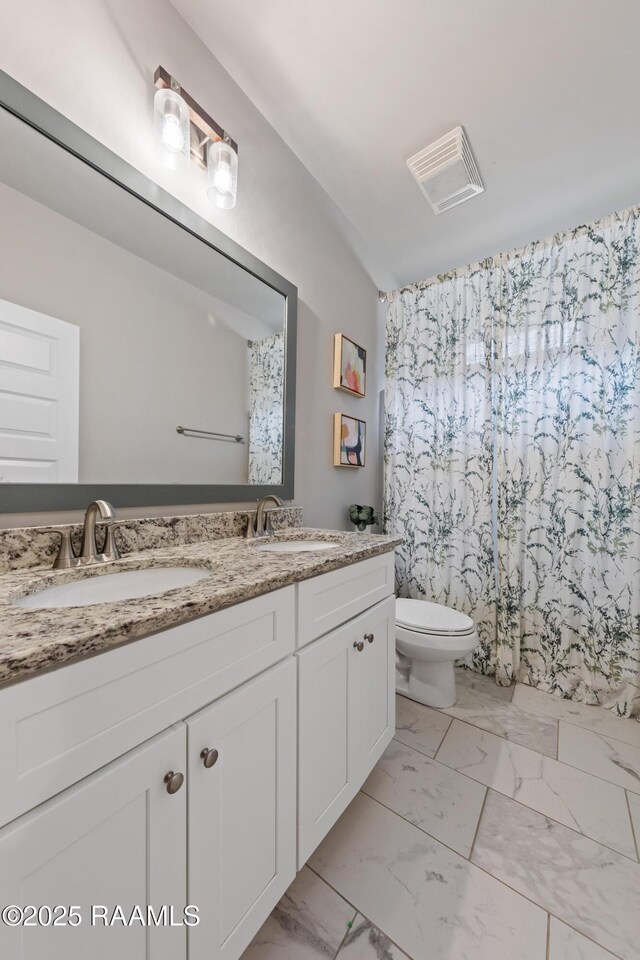 bathroom with vanity and toilet