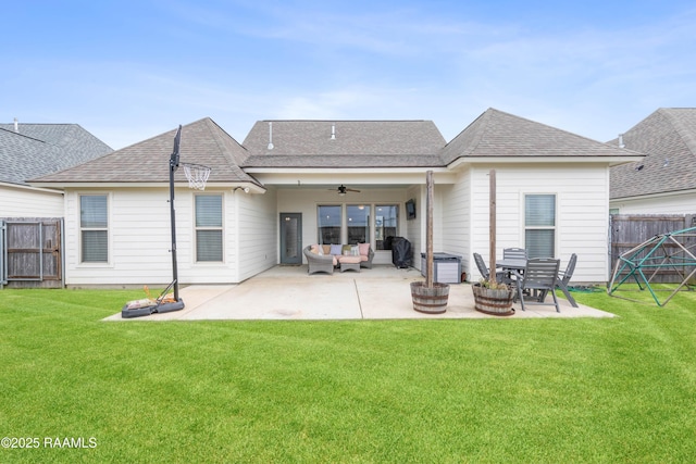 back of property with ceiling fan, a lawn, outdoor lounge area, and a patio area