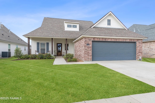 view of front of home featuring covered porch, a garage, central AC, and a front yard