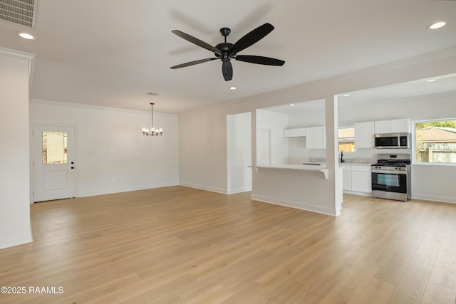 unfurnished living room featuring sink, ceiling fan with notable chandelier, light hardwood / wood-style flooring, and ornamental molding