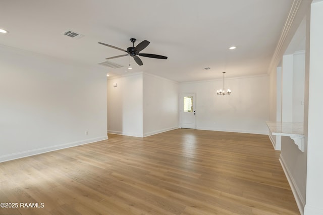 empty room with crown molding, light hardwood / wood-style flooring, and ceiling fan with notable chandelier