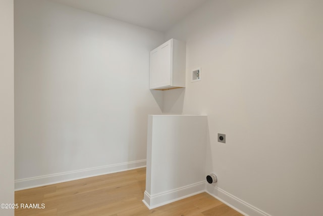 laundry area with cabinets, electric dryer hookup, and light wood-type flooring