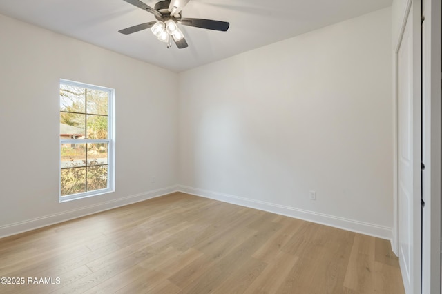 empty room featuring ceiling fan, light hardwood / wood-style flooring, and a healthy amount of sunlight