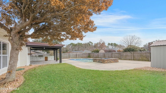 view of yard featuring a swimming pool with hot tub, a patio, and area for grilling