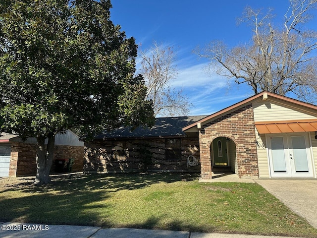 view of front of house featuring a front lawn and french doors