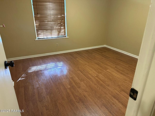 spare room featuring wood-type flooring