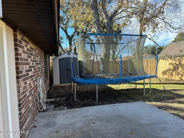 exterior space with a trampoline and a shed