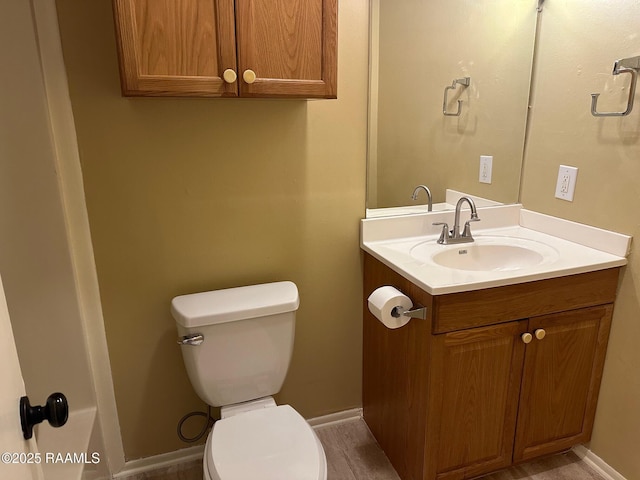 bathroom featuring toilet and vanity