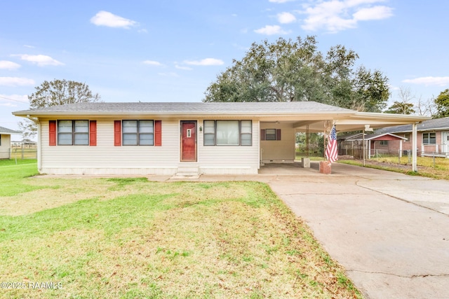 view of front facade with a front yard and a carport