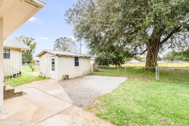 view of yard featuring a patio area and a storage shed