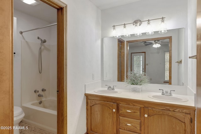 full bathroom featuring tile patterned flooring, vanity, shower / washtub combination, toilet, and ceiling fan