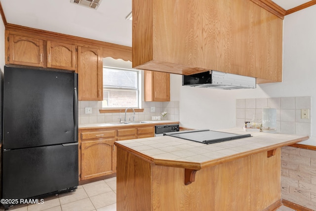 kitchen with black appliances, kitchen peninsula, sink, tile counters, and light tile patterned floors