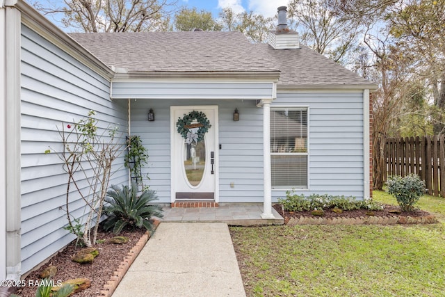 doorway to property with a lawn