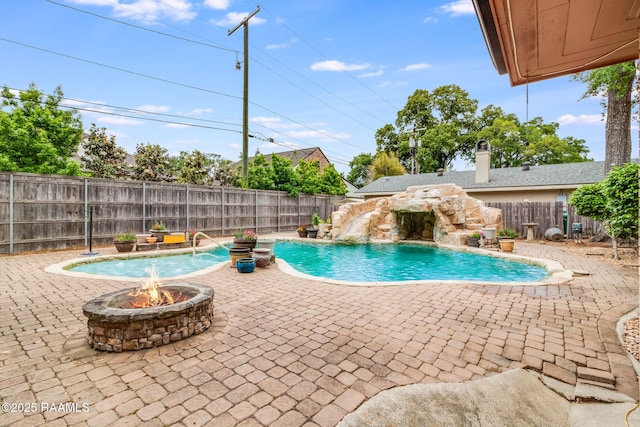 view of pool featuring an outdoor fire pit, a patio area, and pool water feature