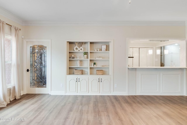 unfurnished living room featuring crown molding and light hardwood / wood-style flooring