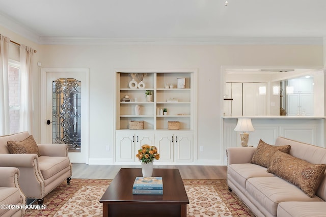 living room with ornamental molding and light hardwood / wood-style flooring