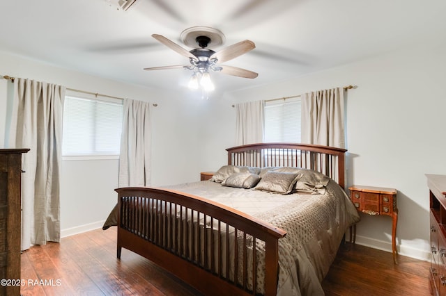 bedroom with ceiling fan and dark hardwood / wood-style flooring