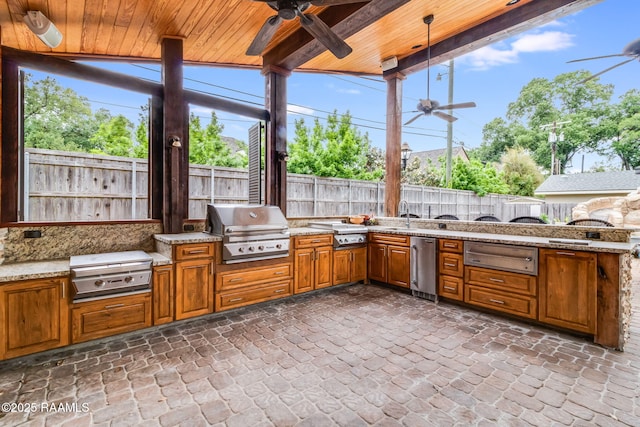 view of patio / terrace with area for grilling, ceiling fan, and a grill