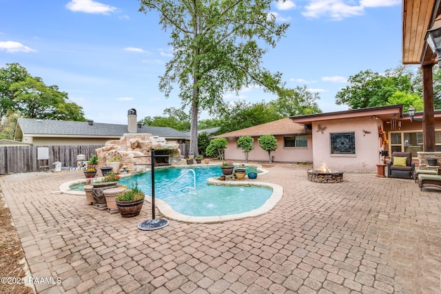 view of swimming pool featuring a fire pit and a patio area