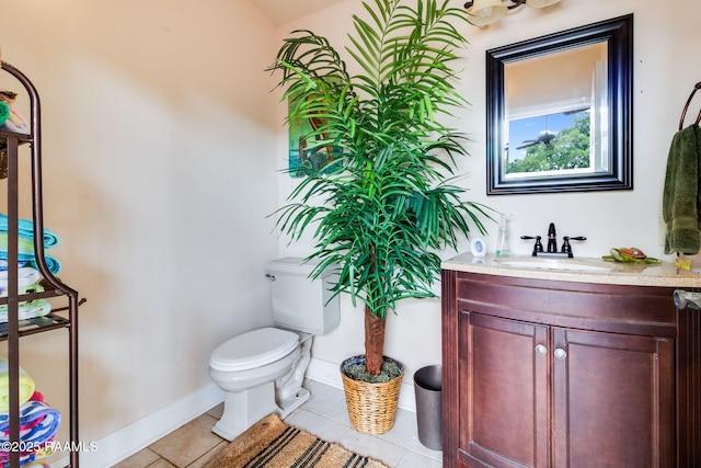 bathroom featuring toilet, vanity, and tile patterned floors