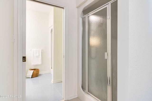 bathroom featuring a shower with door