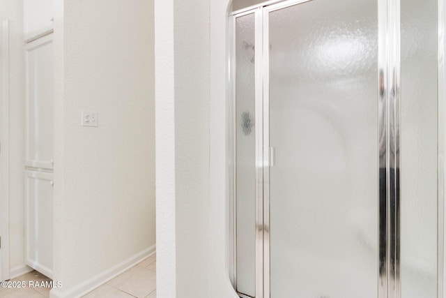 bathroom featuring tile patterned floors and an enclosed shower