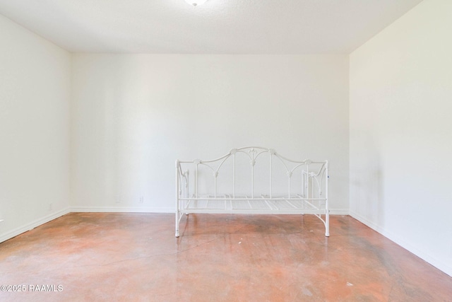 unfurnished bedroom with concrete floors