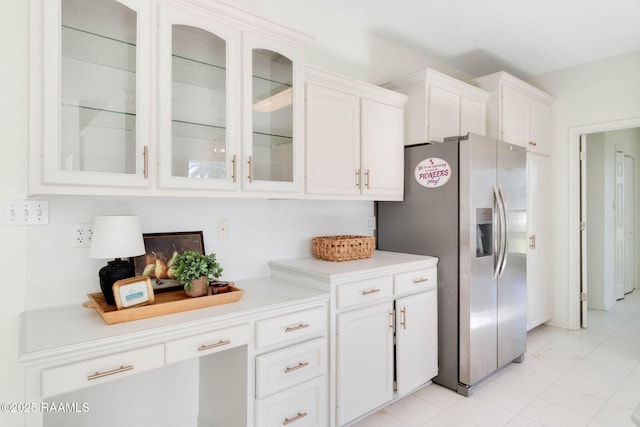 kitchen featuring white cabinetry, stainless steel fridge, and light tile patterned flooring