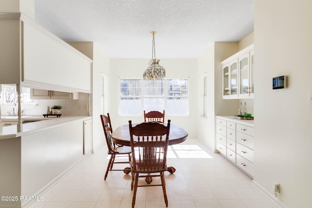 dining room with plenty of natural light, a textured ceiling, and a notable chandelier