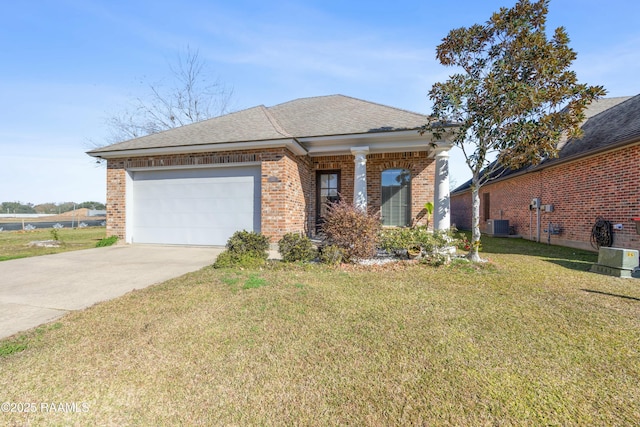 view of front of house with a garage, cooling unit, and a front lawn