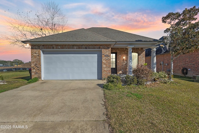 view of front of house with a garage and a yard