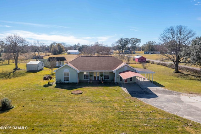 view of front of home with a front lawn and a storage unit