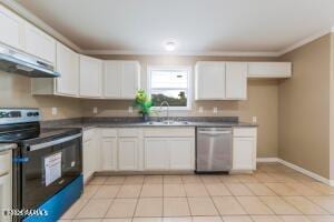 kitchen with sink, white cabinets, stainless steel appliances, and light tile patterned flooring