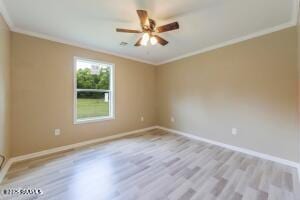 empty room featuring ceiling fan, crown molding, and light wood-type flooring